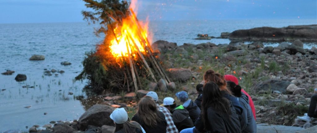 Nuoria katselemassa kokkotulta